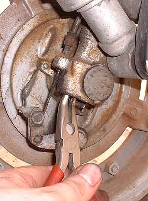 Removing speedometer gear with needle-nosed pliers